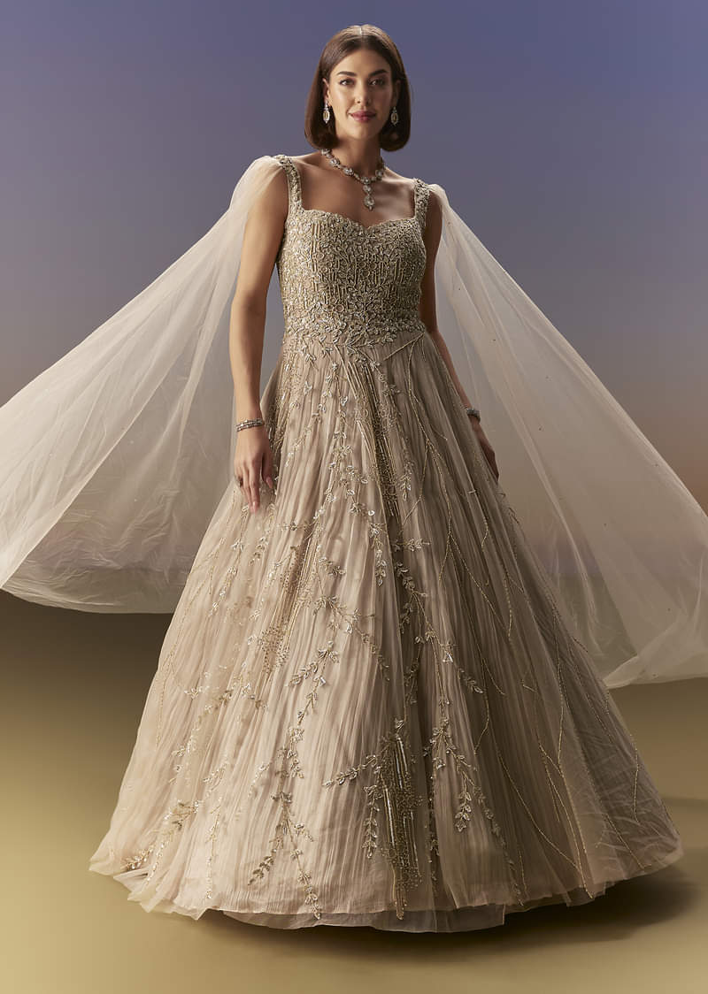 Gold Gown With Pleated Panels And Dramatic Cape - Image 4