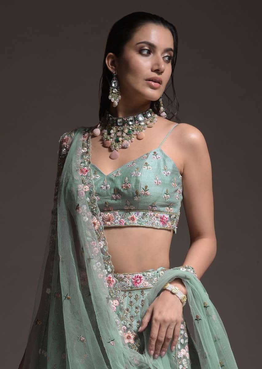 Sage Green Lehenga Choli In Raw Silk With Vibrant Resham Embroidered Cluster Of Summer Blooms And Buttis - Image 13
